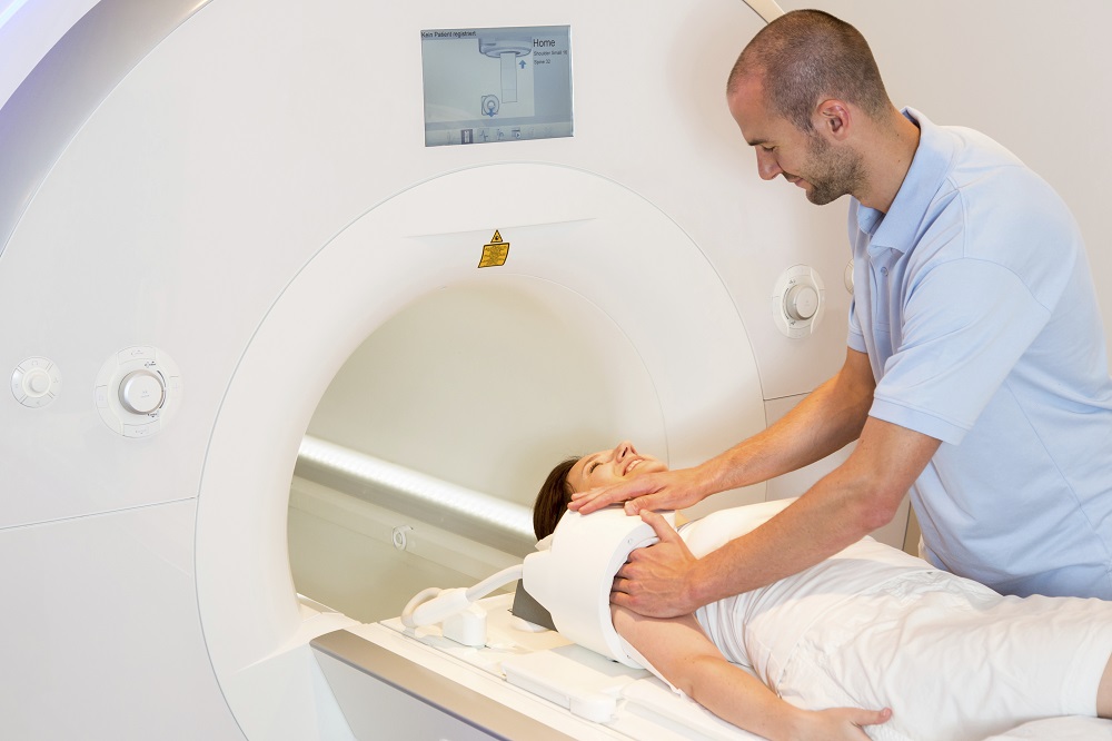 Medical Technical Assistant Preparing Scan of Shoulder with MRI